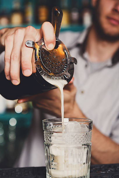 istock Young Barman's making shot cocktail, pouring syrup into glass 626592896