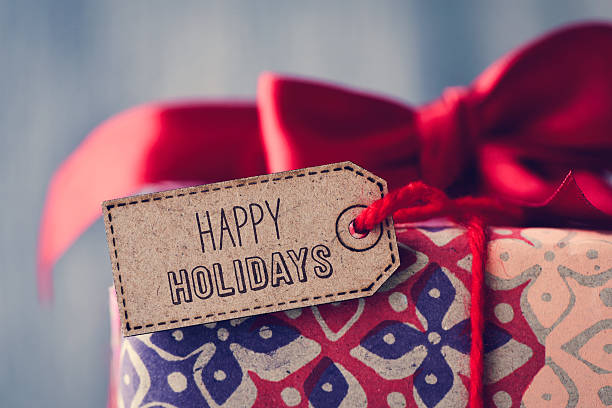 istock gift with a label with the text happy holidays 626593160
