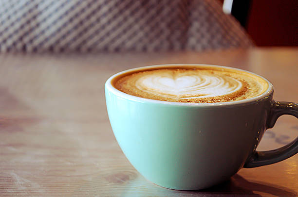 istock Coffee in blue cup on wooden table 626602554
