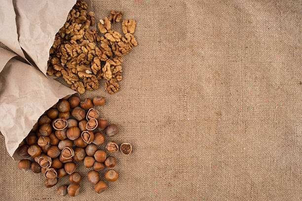 istock Walnuts and hazelnuts in the paper on the sacking. 626602638