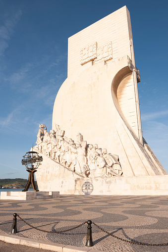 Lisbon, Portugal - July 3, 2012: Monument to the Discoveries (Padrão dos Descobrimentos) located in the Belem district on the northern bank of the Tagus River (where ships departed to explore and trade with India and Orient) in Lisbon city in Portugal. The monument celebrates the Portuguese Age of Discovery (or Age of Exploration) during the 15th and 16th centuries. The person depicted in front of the the ship is Henry the Navigator, holding a model of a carrack.