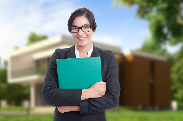 istock Friendly estate consultant holding big folder 626605436