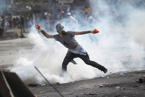 Gezi Park Protests Istanbul, Turkey - June 11, 2013: Hundreds of protesters clashed with police in Taksim Square. A wave of demonstrations and civil unrest in Turkey began on 28 May 2013, initially to contest the urban development plan for Istanbul's Taksim Gezi Park. The protests were sparked by outrage at the violent eviction of a sit-in at the park protesting the plan. riot tear gas stock pictures, royalty-free photos & images