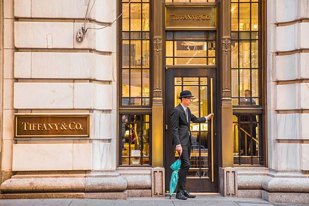 Tiffany & Co. NYC New York City, New York, USA - September 17, 2016:   Exterior view of Tiffany & Co. on Wall Street in Manhattan with doorman.  Tiffany is a world  premier jeweler since 1837. door attendant photos stock pictures, royalty-free photos & images
