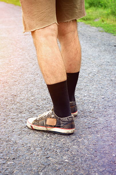 istock man legs in shorts and sneakers 626611334