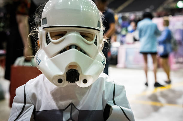 Young girl cosplaying as a stormtrooper Sheffield, United Kingdom - June 12, 2016: Young girl dressed as a stormtrooper from 'Star Wars' at the Yorkshire Cosplay Convention at Sheffield Arena cosplay stock pictures, royalty-free photos & images