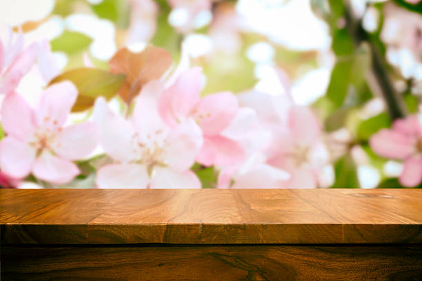 Empty top wooden table and floral blurred background