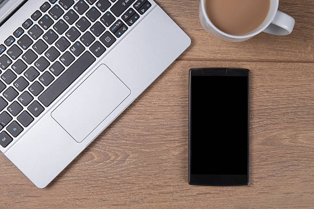 istock Open laptop with coffee and a mobile phone 626611870