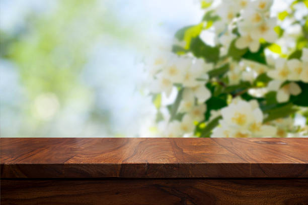 Empty top wooden table and floral blurred background