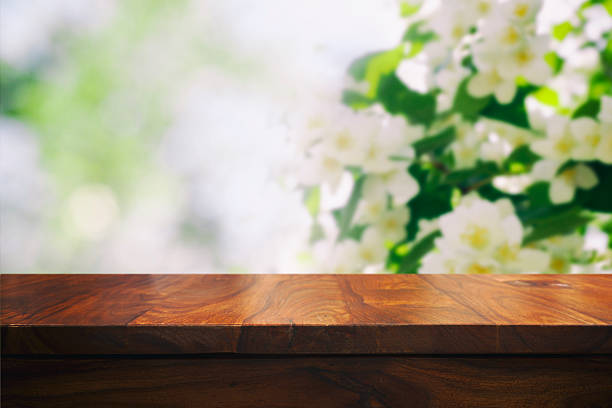 istock Empty top wooden table and floral blurred background 626611940