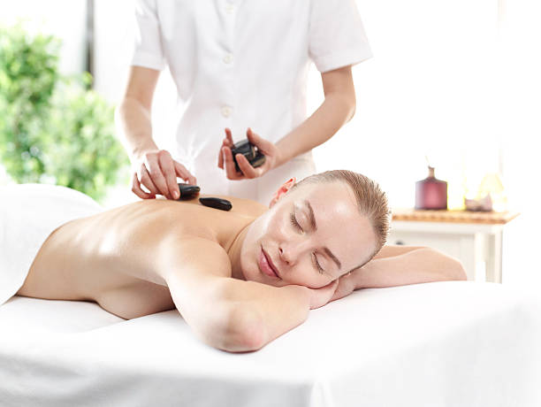 istock Young woman having volcanic stone therapy 626612232