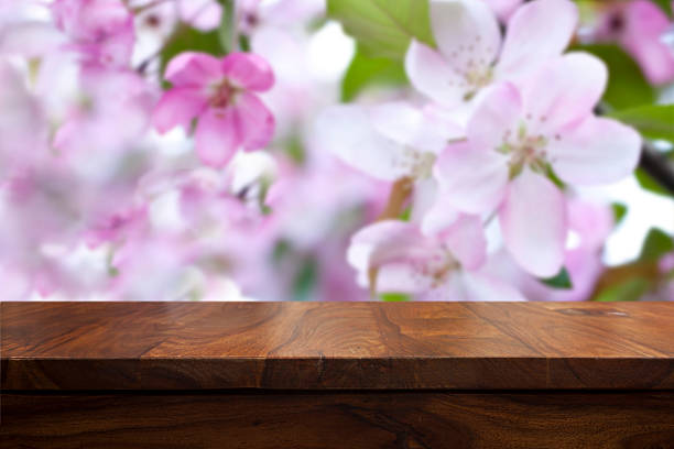 istock Empty top wooden table and floral blurred background 626616644