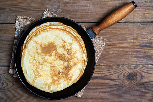 Stack of pancakes on a cast-iron frying pan stock photo