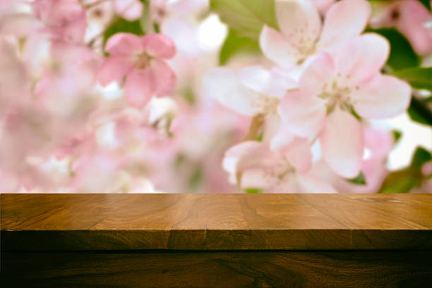 istock Empty top wooden table and floral blurred background 626616762