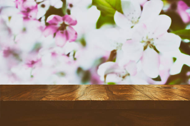 istock Empty top wooden table and floral blurred background 626616866
