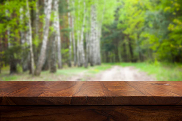 Empty top wooden table and floral blurred background