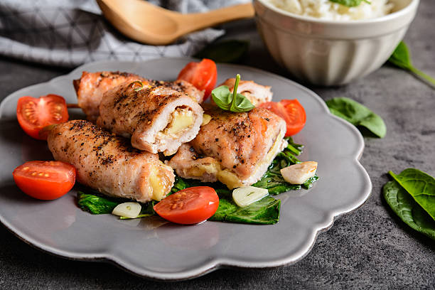 istock Roasted turkey breasts stuffed with Camembert, served with rice 626617822