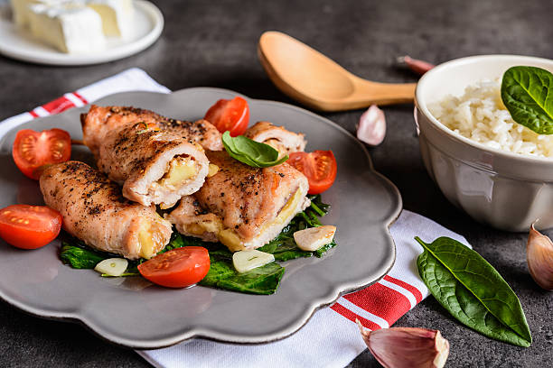 istock Roasted turkey breasts stuffed with Camembert, served with rice 626618192