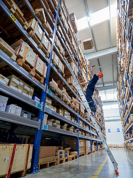 istock Man looking up at box falling on him, warehouse 626618260