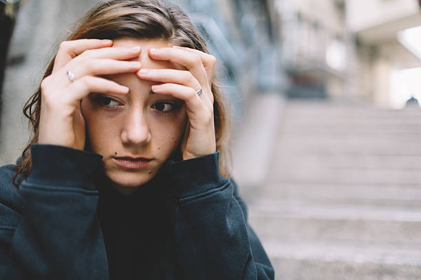 istock Depressed woman with head in hands 626621572