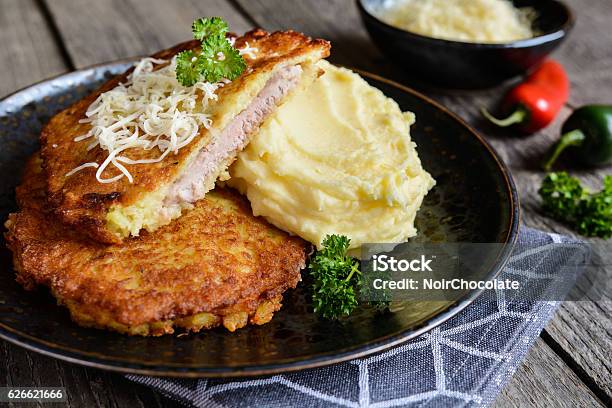 Pork Cutlets Coated In Potato Batter Served With Mashed Potatoes Stock Photo - Download Image Now