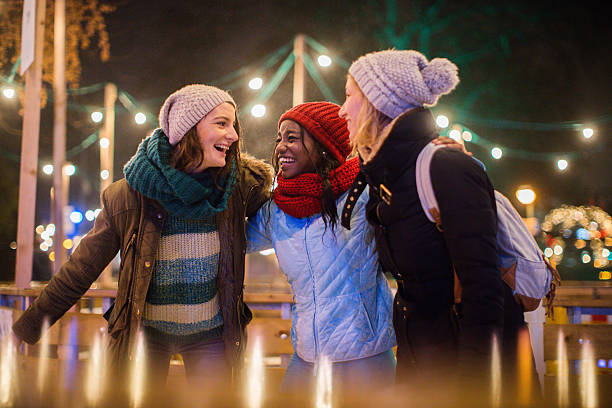 Having fun on Christmas market Photo of a cheerful friends spending time on Christmas market during holidays  ice skating stock pictures, royalty-free photos & images