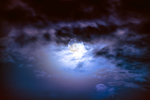 istock Nighttime sky with clouds and bright full moon with shiny. 626624742
