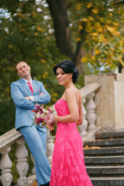 istock Luxurious couple, brunette stands sideways in a bright pink tigh 626625870