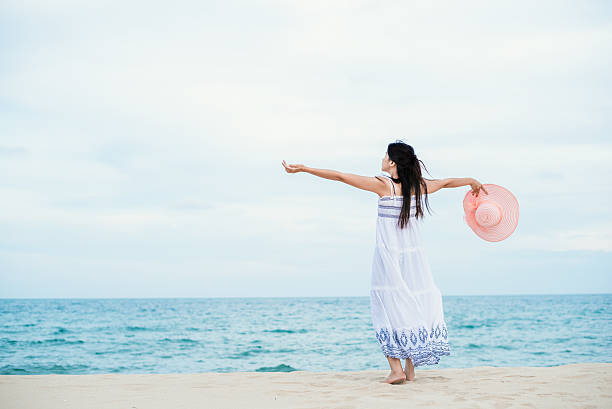 istock Women open arm with colour hat on the beach. 626626746