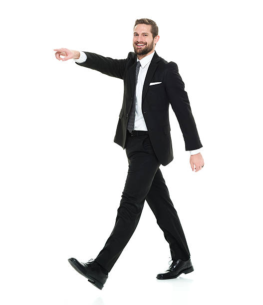istock Smiling businessman pointing and walking 626626774