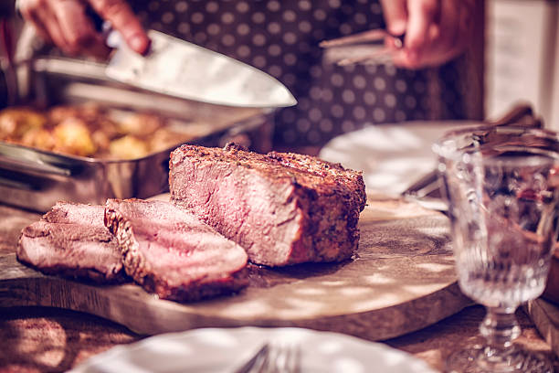 istock Cutting Roast Beef with Potatoes and Root Vegetables 626628784