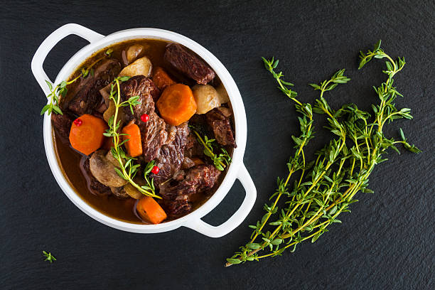 istock Beef Bourguignon in a white soup bowl on black stone 626628916
