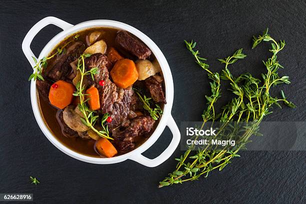 Beef Bourguignon In A White Soup Bowl On Black Stone Stock Photo - Download Image Now