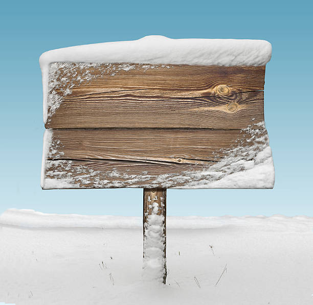 istock Wooden signpost with snow and blue sky 626629292