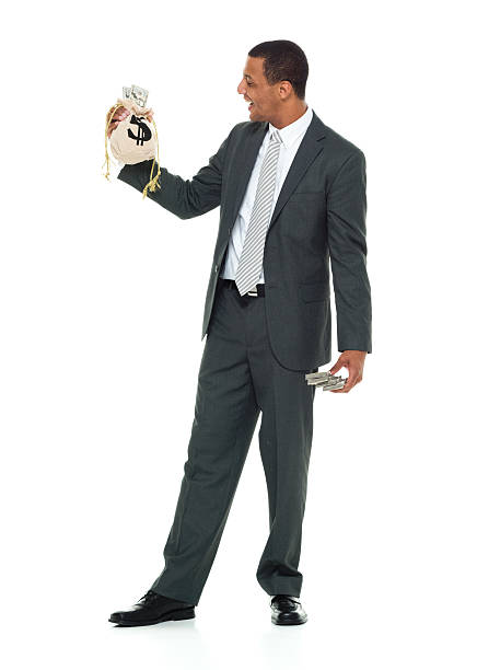 Smiling businessman holding money bag