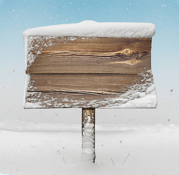 istock Wooden signpost with snow on it and snowfall 626629702