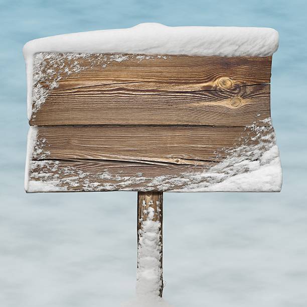 istock Wooden sign with snow on it and snow bg 626630356
