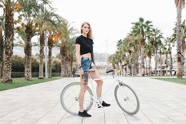 istock Tattooed Woman Sitting on a Fixie 626631400