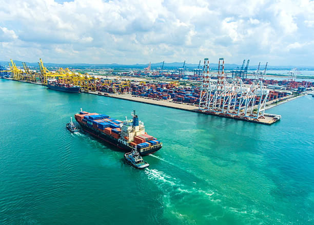 istock container ship in import export and business logistic.By crane , 626631968