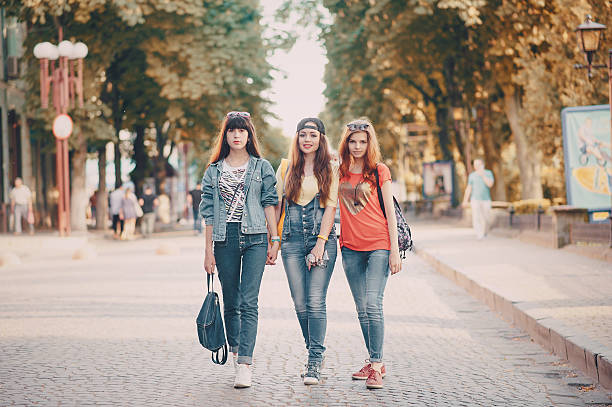 istock three young girls walking in the park 626632024