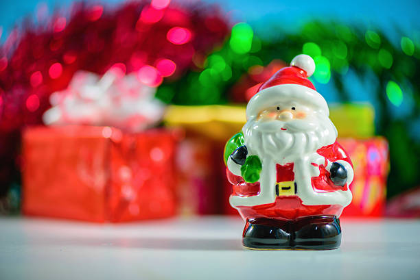 istock Santa Claus dolls and  blurred Christmas decorations box 626637100