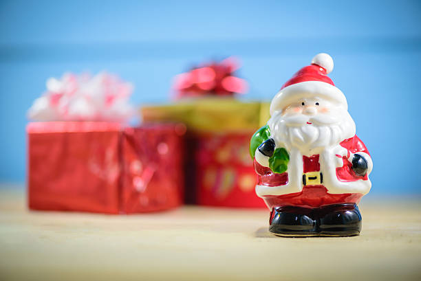 istock Santa Claus dolls and  blurred Christmas decorations box 626637114