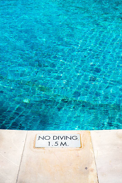 istock swimming pool edge with 'No Diving' warn sign 626637144
