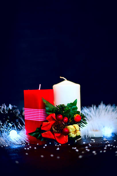 istock Red and white candles with garland at black background 626637298