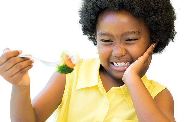 istock Close up of african girl refusing vegetables. 626639112