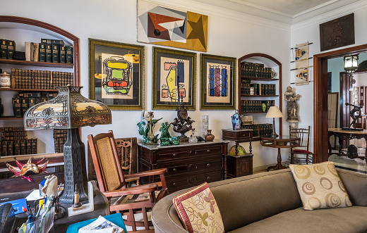 Havana, Cuba - October 12, 2016: Interior of  old Villa in Vedado, suburbs of Havana. Library area with art work all around. This property is owned by middle aged Cuban Architect. It serves as his residence as well as 