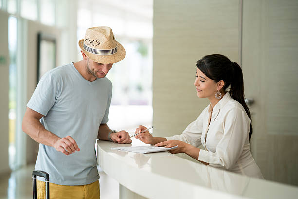 istock Man doing the check-in at the hotel 626640820