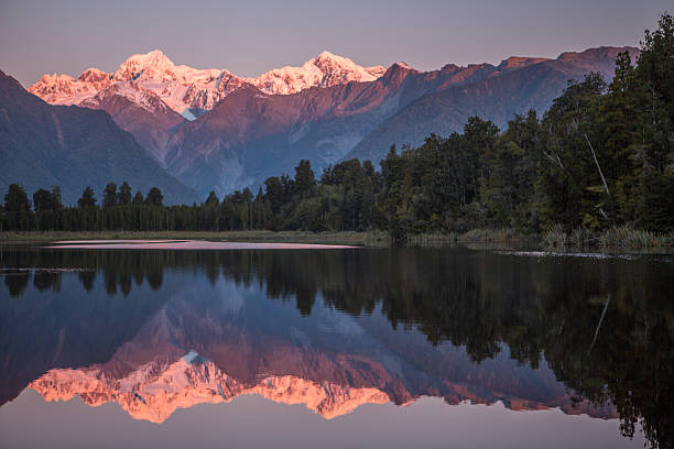 istock Snowcapped Mountains Reflected In Tranquil Lake 626642188