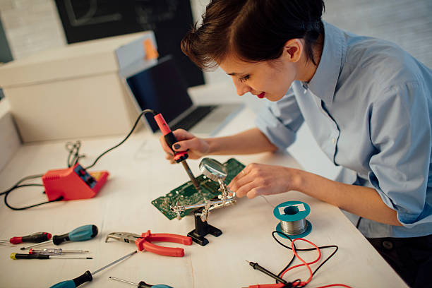 istock Woman Soldering a circuit board in her tech office. 626642318