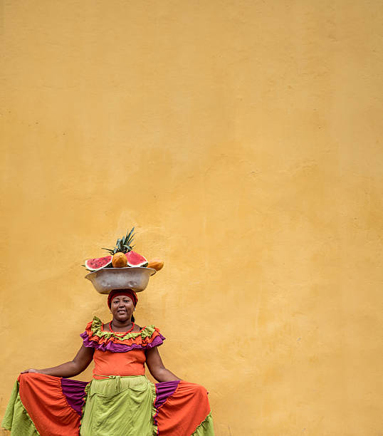 Beautiful Palenquera in Cartagena Beautiful Palenquera selling fruits in Cartagena and looking at the camera smiling cartagena colombia stock pictures, royalty-free photos & images
